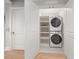 A well-organized laundry room with a stackable washer and dryer, complemented by shelving at 12 Country Club Ln, Belleair, FL 33756