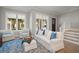 Bright living room featuring large windows and a comfortable white sofa with blue accents at 12 Country Club Ln, Belleair, FL 33756