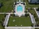 Beautiful pool and lawn area with lounge chairs and palm trees at 12 Country Club Ln, Belleair, FL 33756