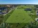 Aerial view of a golf putting green with players in a lush landscape at 12 Country Club Ln, Belleair, FL 33756