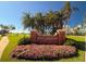 Belleair Country Club sign with a beautiful flower bed in front of it at 12 Country Club Ln, Belleair, FL 33756