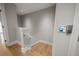 A well-lit stairway with oak floors provides access to the next level of the home at 12 Country Club Ln, Belleair, FL 33756