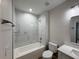 Bathroom features tile surround, bathtub, and vanity with sink at 12047 Henley Ave, Port Charlotte, FL 33981