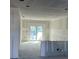 Spacious unfinished living room area featuring sliding glass doors to let in natural light at 12047 Henley Ave, Port Charlotte, FL 33981
