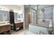 Well-lit bathroom with double sinks, granite counters, and tiled shower, providing a spa-like experience at 12808 Killarney Ct, Odessa, FL 33556