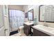 Functional bathroom with double sinks, mirror, and shower, offering a practical space at 12808 Killarney Ct, Odessa, FL 33556