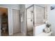 Bright bathroom featuring a walk-in shower with decorative tiled trim and a separate water closet at 12808 Killarney Ct, Odessa, FL 33556