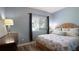 Bedroom featuring a queen size bed, light blue walls, and wood laminate flooring at 12808 Killarney Ct, Odessa, FL 33556