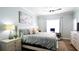 Cozy bedroom with soft blue walls, natural lighting, a ceiling fan, and a comfortable bed at 12808 Killarney Ct, Odessa, FL 33556