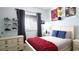 Bright bedroom with sports decor, a comfy bed with blue accents, and a dresser for storage at 12808 Killarney Ct, Odessa, FL 33556