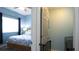 View from doorway into the bedroom showcasing the bed and a peek into the laundry room at 12808 Killarney Ct, Odessa, FL 33556
