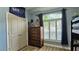 Light-filled bedroom with wood floors, large window, and closet, offering comfort and style at 12808 Killarney Ct, Odessa, FL 33556