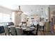 Elegant dining room featuring a stylish chandelier and seamless flow into the kitchen with breakfast bar seating at 12808 Killarney Ct, Odessa, FL 33556