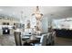 Elegant dining area featuring a wood table, chandelier lighting, and seamless flow to a modern kitchen at 12808 Killarney Ct, Odessa, FL 33556
