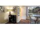 Well-lit dining space showcasing a modern shelf, artwork, and natural light from the window at 12808 Killarney Ct, Odessa, FL 33556