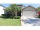 Beautiful single Gathering home featuring tropical landscaping, a two car garage and a covered entryway at 12808 Killarney Ct, Odessa, FL 33556