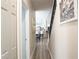 Hallway leading to the kitchen with hardwood floors and a view of the staircase on the right at 12808 Killarney Ct, Odessa, FL 33556