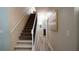 Well-lit hallway with stairs leading to the upper level and neutral color scheme at 12808 Killarney Ct, Odessa, FL 33556