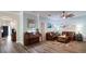 Spacious living room with hardwood floors, a leather sofa, piano, and light blue accent walls at 12808 Killarney Ct, Odessa, FL 33556