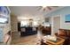 Spacious living room with a fireplace, piano, and comfortable seating, perfect for relaxation at 12808 Killarney Ct, Odessa, FL 33556