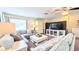 Comfortable living room with plush sofas, a large TV, and soft lighting, perfect for relaxation at 12808 Killarney Ct, Odessa, FL 33556