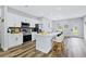Bright kitchen boasts white cabinets, stainless steel appliances, an island with seating, and modern backsplash at 13266 Drysdale Ave, Port Charlotte, FL 33981