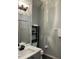 Bathroom featuring a white vanity, gray cabinets, and decorative black shelving at 14510 Mj Rd, Myakka City, FL 34251