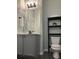 Well-lit bathroom with vanity, sleek fixtures, storage shelves, and modern toilet at 14510 Mj Rd, Myakka City, FL 34251