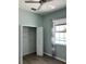 Bedroom with light green walls, a ceiling fan, closet, and a window with a pool view at 14510 Mj Rd, Myakka City, FL 34251