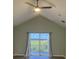 Vaulted ceiling primary bedroom boasting sliding door to balcony with field view at 14510 Mj Rd, Myakka City, FL 34251