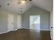 Primary bedroom with vaulted ceilings, two closets, and beautiful flooring at 14510 Mj Rd, Myakka City, FL 34251
