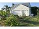 Exterior shot of home with a multi-car garage, beautiful landscaping and a metal roof at 14510 Mj Rd, Myakka City, FL 34251