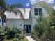 Inviting two-story home featuring a modern design, lush landscaping, and a durable metal roof at 14510 Mj Rd, Myakka City, FL 34251