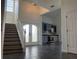 Grand foyer with high ceilings, bar, wine coolers, and beautiful staircase at 14510 Mj Rd, Myakka City, FL 34251