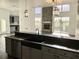 Open-concept kitchen with black granite countertops and a stylish black undermount sink at 14510 Mj Rd, Myakka City, FL 34251
