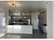 Bright kitchen with stainless appliances, granite countertops and gray cabinets at 14510 Mj Rd, Myakka City, FL 34251