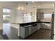 Kitchen with black granite countertops, stainless steel appliances, and modern pendant lighting at 14510 Mj Rd, Myakka City, FL 34251