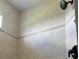 Walk-in shower features neutral tiles and a rain shower head with bronze fixtures at 14510 Mj Rd, Myakka City, FL 34251