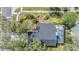 Aerial shot of a beautiful home with a screened-in pool and mature trees and landscaping at 15202 Heathridge Dr, Tampa, FL 33625