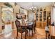 Inviting dining room with warm wood floors, cabinetry, and an open view to the kitchen offering a seamless entertaining space at 15202 Heathridge Dr, Tampa, FL 33625