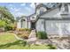 Inviting home featuring a well-manicured lawn and flower beds, offering a warm and welcoming entrance at 15202 Heathridge Dr, Tampa, FL 33625