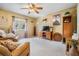 Comfortable living room with a ceiling fan, a cozy couch, and a large window offering a relaxing space at 15202 Heathridge Dr, Tampa, FL 33625