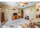 Cozy living room featuring neutral carpeting, a ceiling fan, and comfortable seating for a relaxing atmosphere at 15202 Heathridge Dr, Tampa, FL 33625
