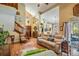 Comfortable living room with an open floor plan that includes a wood staircase and a dining area at 15202 Heathridge Dr, Tampa, FL 33625