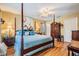 Spacious main bedroom with a four-poster bed, complemented by warm tones and ample space, creating a cozy retreat at 15202 Heathridge Dr, Tampa, FL 33625