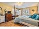 Bright main bedroom featuring a four-poster bed, hardwood floors, a large window, and plenty of natural light at 15202 Heathridge Dr, Tampa, FL 33625