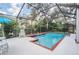 Screened-in pool area with a sparkling blue pool and ample space for outdoor relaxation and entertaining at 15202 Heathridge Dr, Tampa, FL 33625