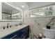 Modern bathroom featuring marble countertops and a double sink vanity at 1546 69Th S Pl, St Petersburg, FL 33705