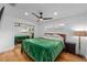 Bright bedroom featuring wood floors, large window, and sliding mirrored closet at 1546 69Th S Pl, St Petersburg, FL 33705