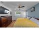 Bedroom with wood floors, a ceiling fan, and a blue accent wall at 1546 69Th S Pl, St Petersburg, FL 33705